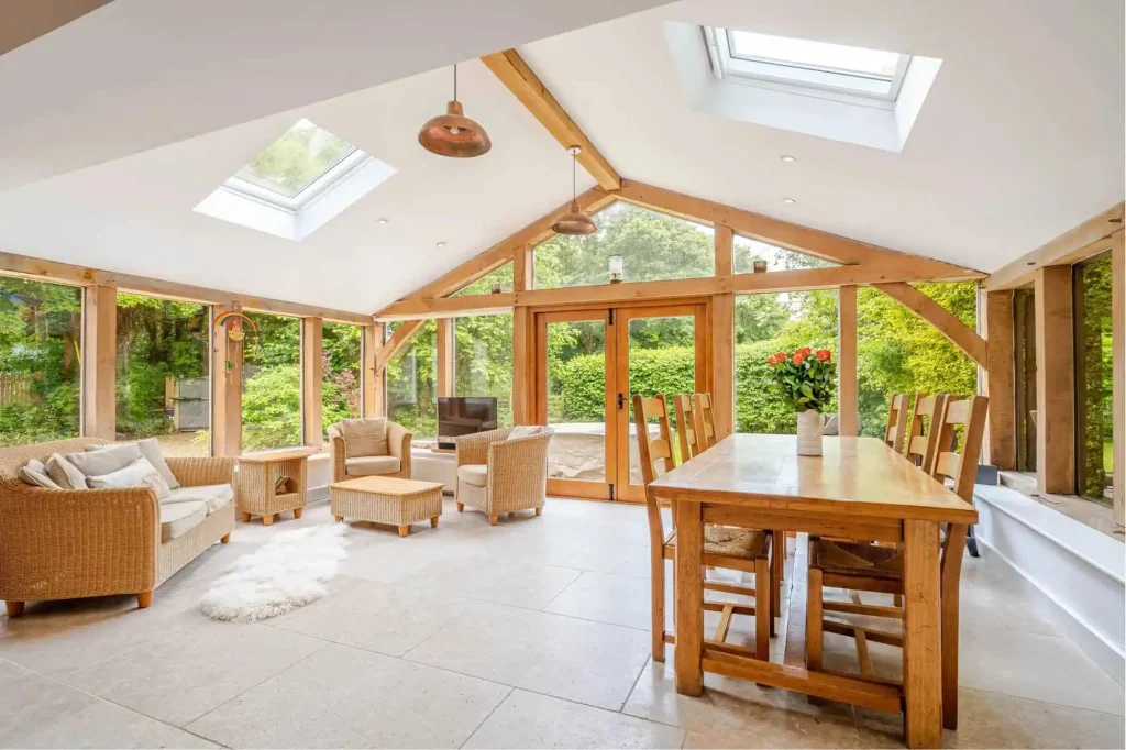Oak framed conservatory creating a bright living space with extensive glazing and exposed oak beams