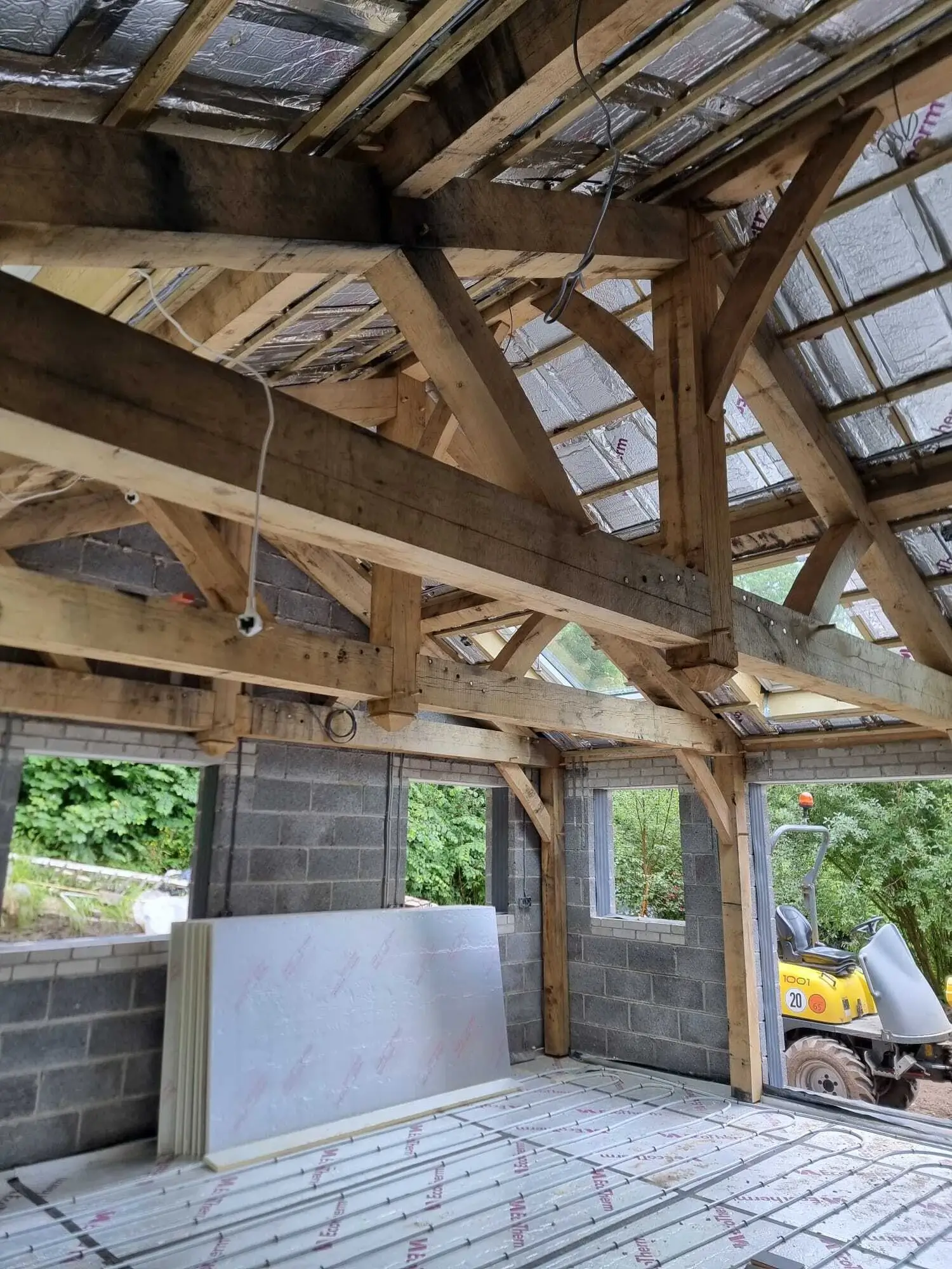 Traditional oak frame under construction for a bespoke kitchen extension showing handcrafted oak beams and clear-span structure.